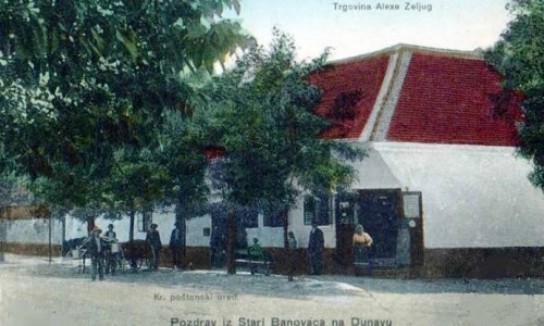 Na staroj razglednici s prve polovine 20. veka vidi se mesto Stari Banovci na Dunavu i trgovačka radnja Alekse Zeljuga iz Starih Banovaca.